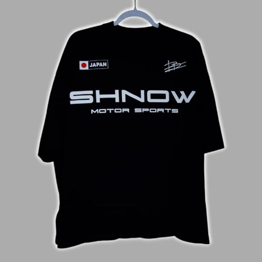 Dion Dawkins Shnow Motor Sports Japan Shirt displayed on a hanger against a grey background.